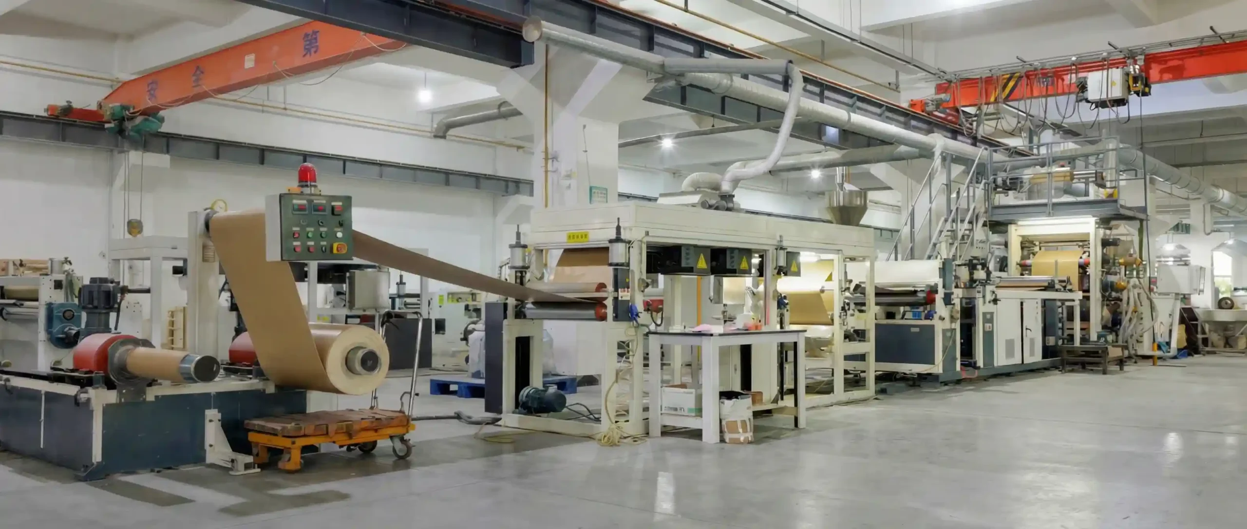 A high-capacity, automated thermoplastic edge banding extrusion line operating inside the clean and modern manufacturing facility of Fujuan Group.