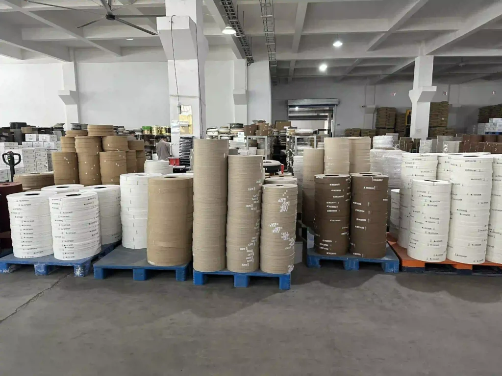 Extensive inventory of PVC and ABS edge banding rolls properly stacked on pallets at the Fujuan Group warehouse, ready for global export logistics.