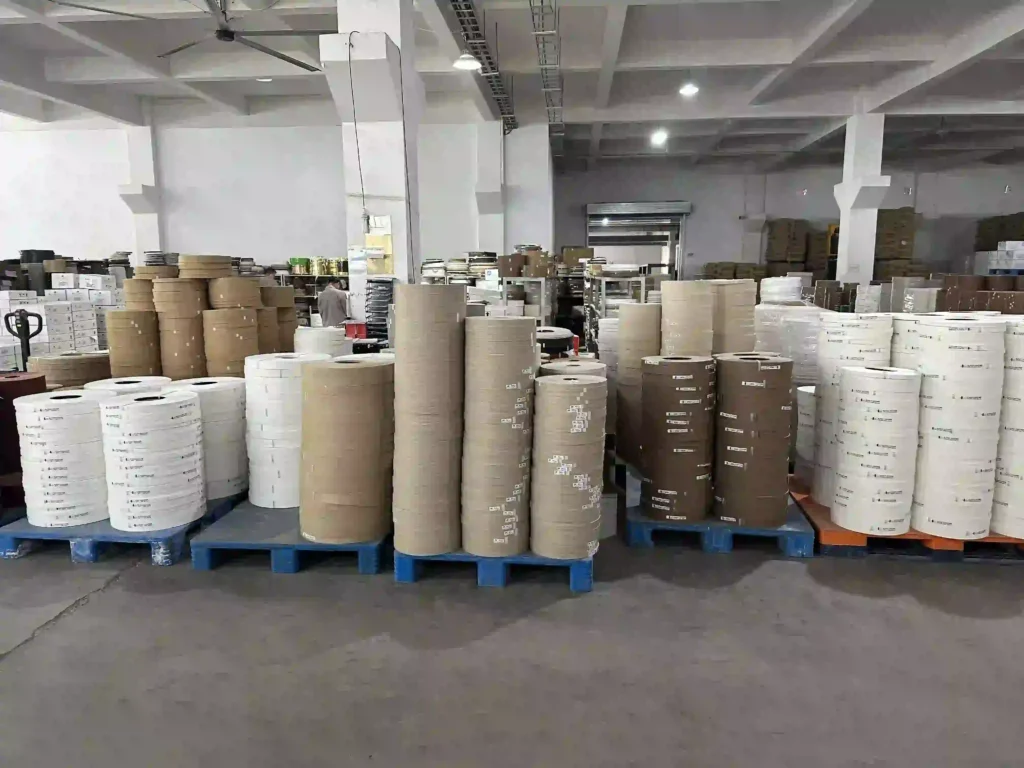 Extensive inventory of PVC and ABS edge banding rolls properly stacked on pallets at the Fujuan Group warehouse, ready for global export logistics.